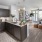 a kitchen with a large island and a living room