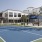 a tennis court with a building in the background