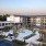 a building with a pool and trees in the front